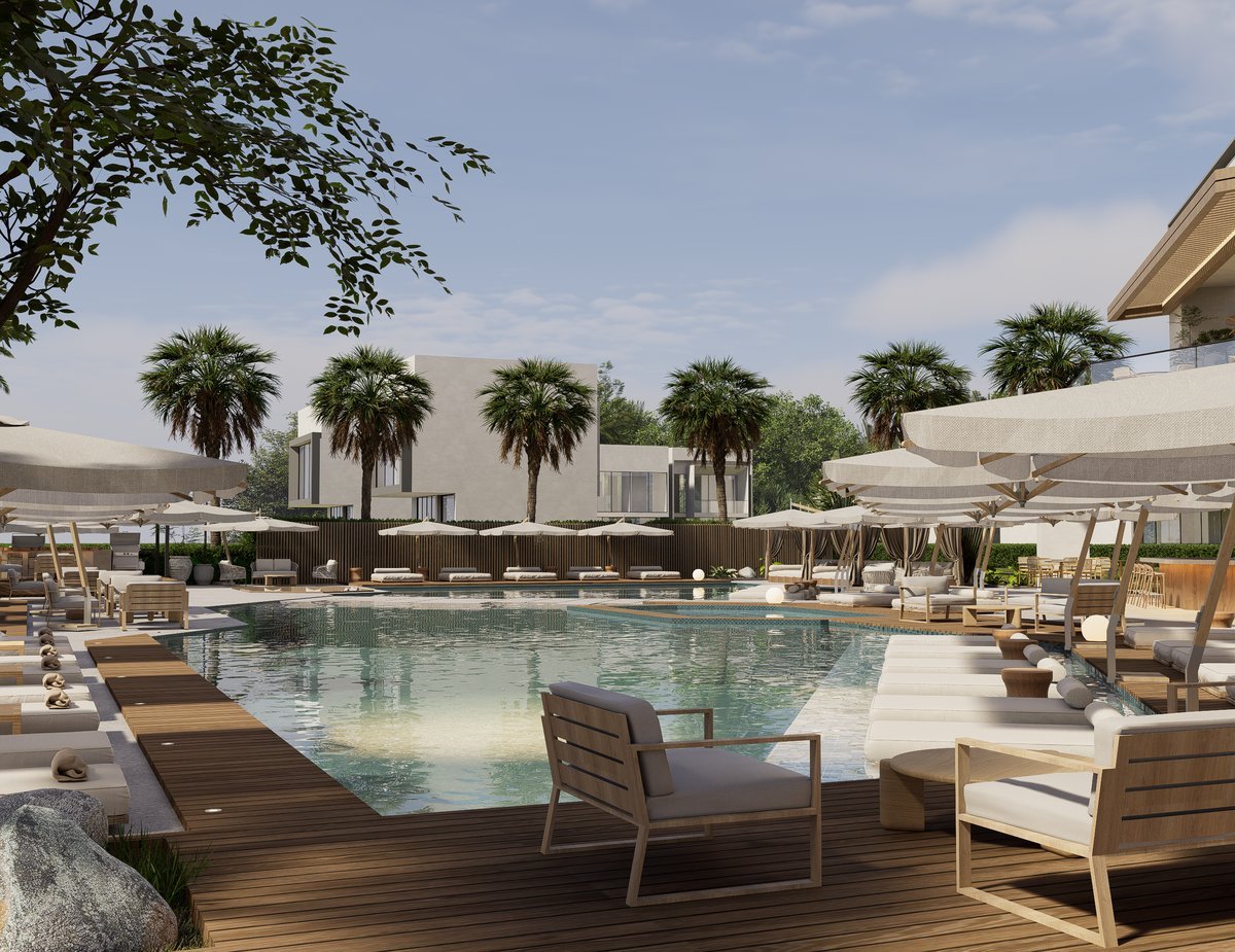 Piscina del club de playa con camas lounge